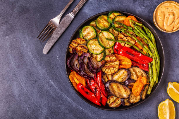 istock Grilled vegetables on a plate with sauce 1050329420