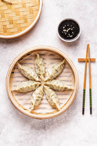 istock Asian dumplings, soy sauce, chopsticks 1050329498