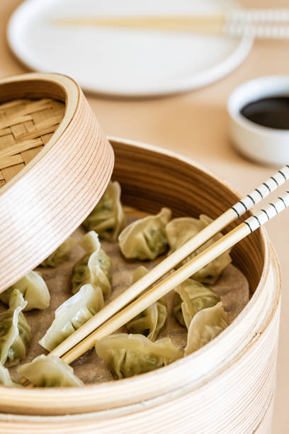 istock Asian gyoza, dumplings snack, chopsticks, steamer 1050329662