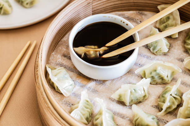 istock Asian gyoza, dumplings snack, chopsticks, steamer 1050329700