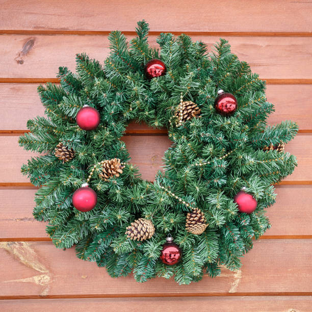 istock Christmas wreath on wooden wall 1050332852