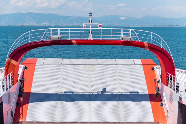 The front side of the vehicle and people carrying ferries between Keramoti and Thasos in Greece