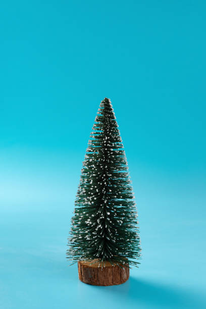 istock Christmas tree with snow on blue background 1050334494