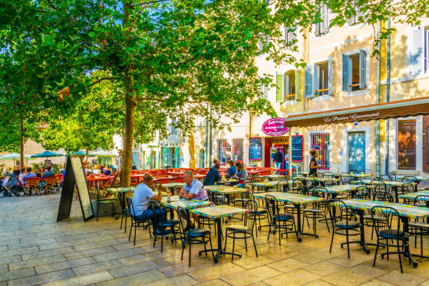 Square full of restaurants at Le Panier part of Marseille, France Marseille, France, June 9, 2017: Square full of restaurants at Le Panier part of Marseille, France store wall surrounding wall facade stock pictures, royalty-free photos & images