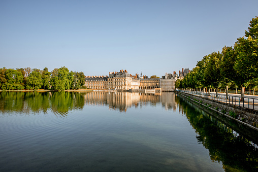FONTAINBLEAU, FRANCE - August 28, 2017: Morning view on the lake in the famous gardens of Fontainebleau palace in France