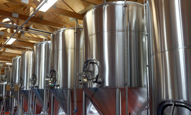 Brewery Tanks Row of shiny metal micro brewery tanks. microbrewery photos stock pictures, royalty-free photos & images