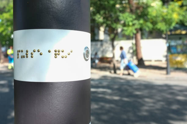 Pedestrian crossing traffic pole for blind people. Emerging lighting on ground and auditive system