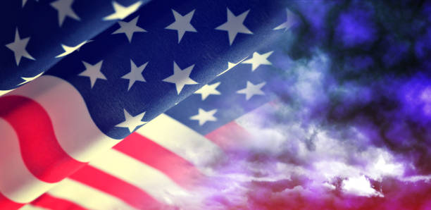 istock American waving flag with stormy sky. 1050362632