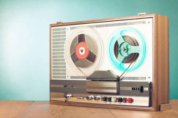 retro reel to reel audio tape recorder on table in front turquoise background. old instagram style filtered photo - 1960s style 1950s style record retro revival imagens e fotografias de stock