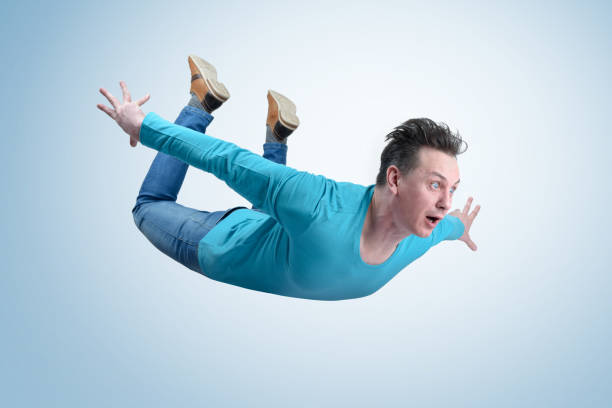 Crazy man in shirt and jeans is flying in the sky. Jumper concept Crazy man in shirt and jeans is flying in the sky. Jumper concept aerobatics photos stock pictures, royalty-free photos & images
