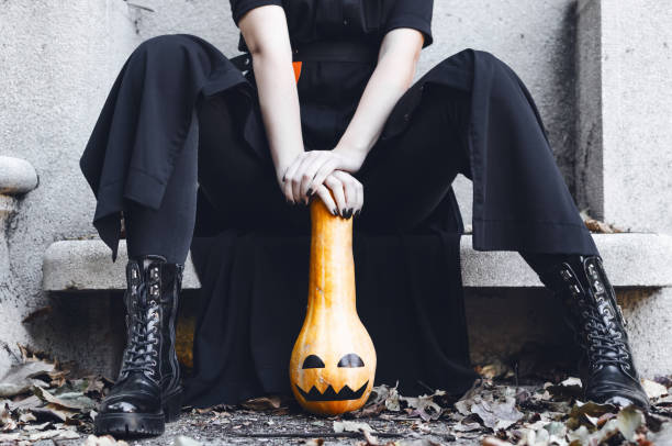 istock Woman posing on monument with pumpkin 1050368614