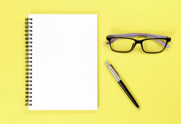 istock Mock up notebook, pen and glasses on colorful background with copy space.view from above 1050371636