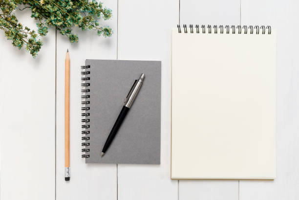 istock Top view, Office desk mock up template with wood table, notebook, pen and pencil. View from above with copy space 1050371742