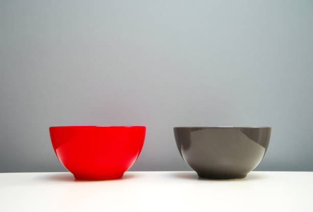 istock red and grey ceramic identical bowl for food contained on white table with grey background 1050374412