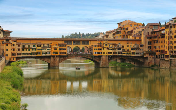View of Ponte Vecchio bridge across Arno river in Florence (Firenze), Tuscany, Italy stock photo