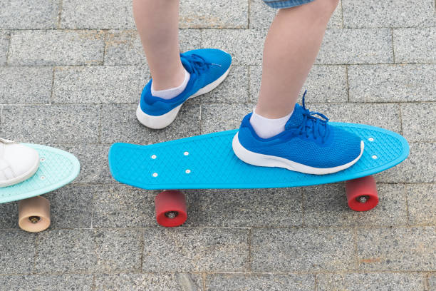 istock legs in blue sneakers on blue skateboard with red wheels 1050377096