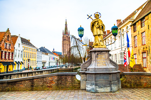 Statue of Saint Joannes Nepomucenus on Wollestraat bridge over Dijver canal in the old town of Bruges (Brugge), Belgium