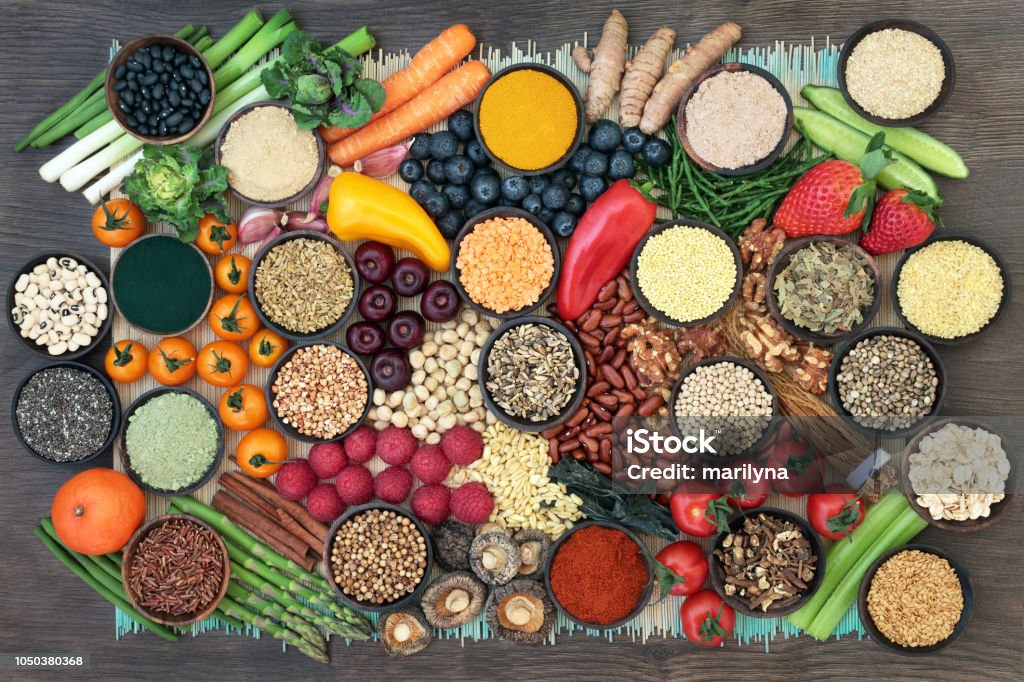 Super Food for Liver Detox Liver detox super food with fruit, vegetables, herbs, spices,legumes, nuts, seeds, grains, cereals and herbal medicine. Health foods high in antioxidants, vitamins  & fibre.  Top view on bamboo and oak. Food Stock Photo