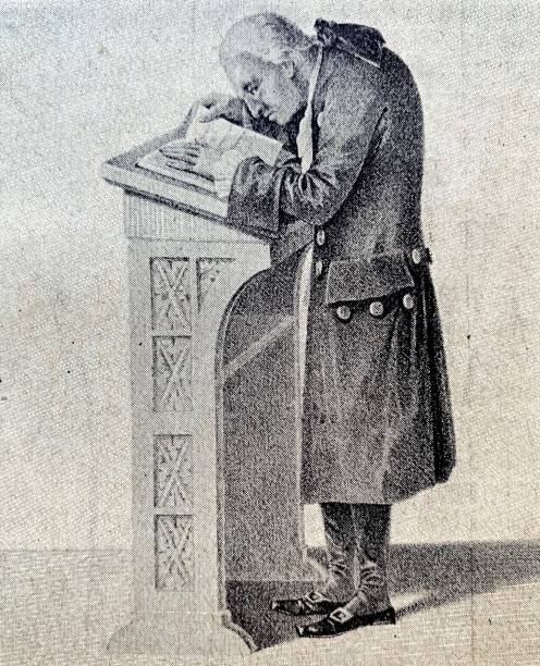 Immanuel Kant reading a book at his lectern Illustration from 19th century immanuel stock illustrations