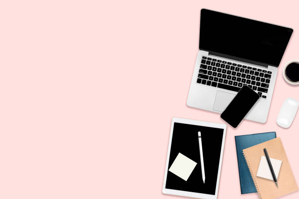 istock Flat lay photo of office table with laptop computer, digital tablet, mobile phone and accessories. on modern pink tone background. Desktop office mockup concept. 1050383466