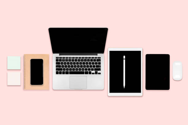 istock Flat lay photo of office table with laptop computer, digital tablet, mobile phone and accessories. on modern pink tone background. Desktop office mockup concept. 1050383578