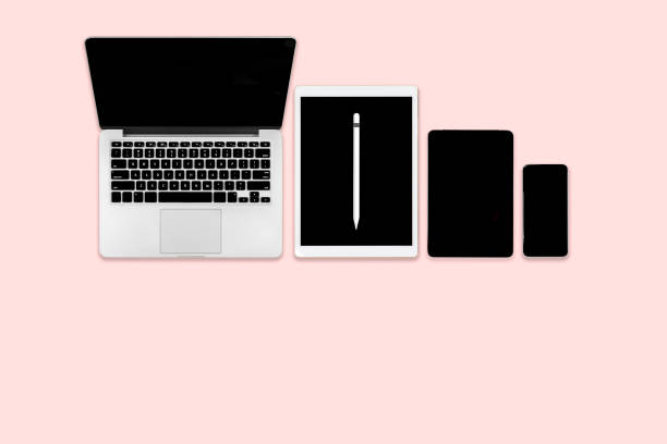 istock Flat lay photo of office table with laptop computer, digital tablet, mobile phone and accessories. on modern pink tone background. Desktop office mockup concept. 1050383644