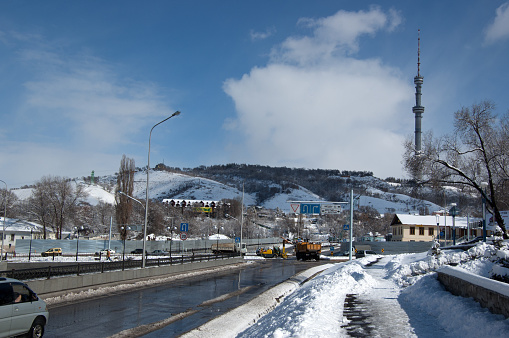 Almaty with the Kok Tobe Hill and its large TV Tower during winter season.