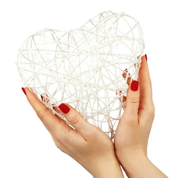 Female Hands Give a Heart on Isolated White Background. Valentine's Day. Heart of Rope.