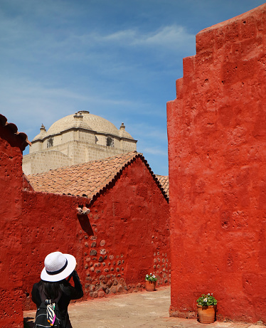 Woman taking pictures of vivid color buildings in Santa Catalina Monastery, Arequipa, UNESCO World Heritage Site, Peru