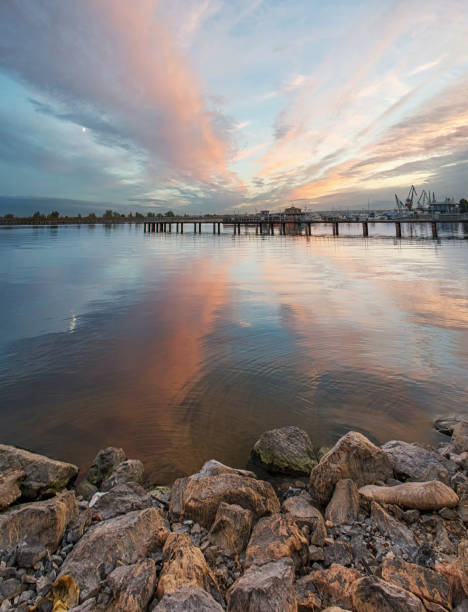 istock Harbor by night with beautiful sunset clouds reflection in the water 1050404712