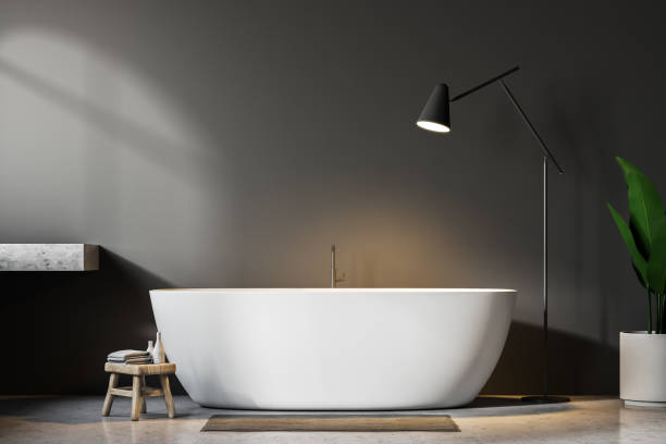 istock Gray bathroom interior, white tub and lamp 1050409936