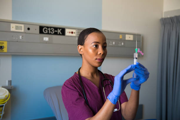 istock Female healthcare worker preparing a sharp for injection 1050413812