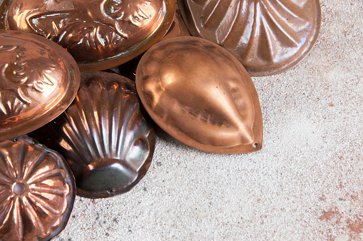 Vintage copper cookie molds on a concrete background. Copy space for text.