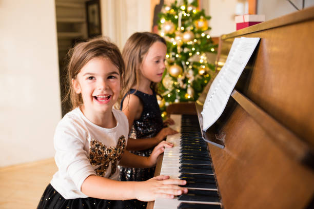 istock Joyful girls playing piano 1050429228