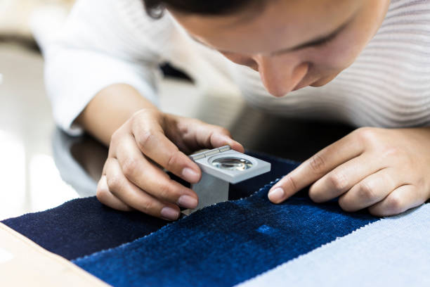 Woman examining fabric quality stock photo