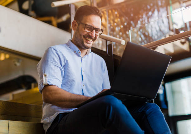 istock Happy businessman sitting indoors 1050431818