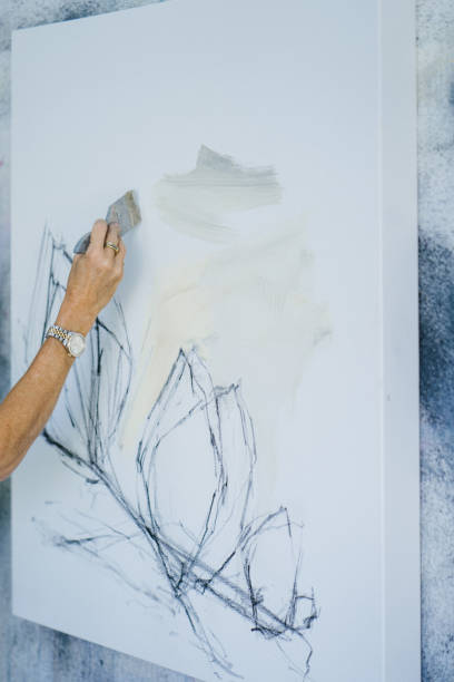 istock Woman painting canvas in art studio 1050437498