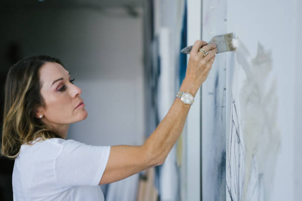istock Woman painting canvas in art studio 1050437520