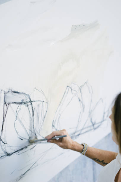 istock Woman painting canvas in art studio 1050437544