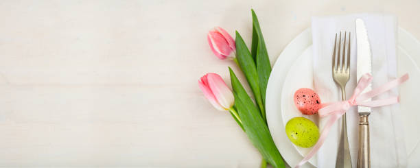 easter table setting with pink tulips on white wooden background. top view, copy space, banner - silverware fork place setting napkin imagens e fotografias de stock