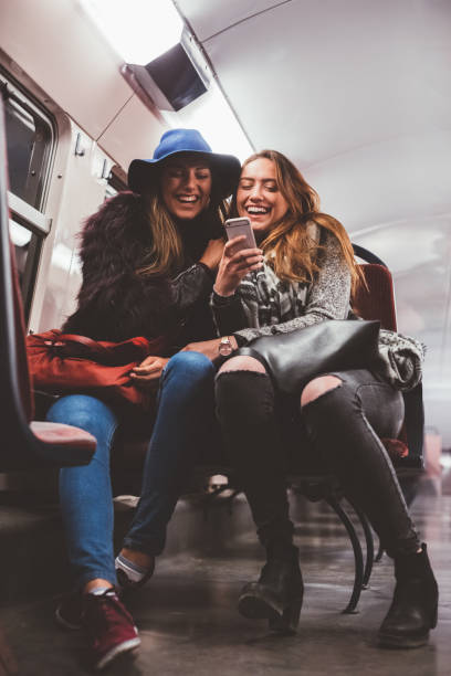istock Friends texting in the subway train 1050459054