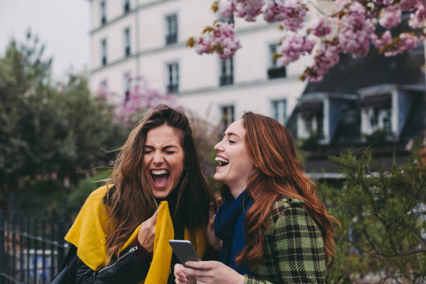 istock Best friends in Paris laughing and texting 1050459116