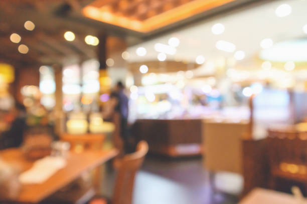 istock Restaurant interior with customer and wood table blur abstract background with bokeh light 1050482584