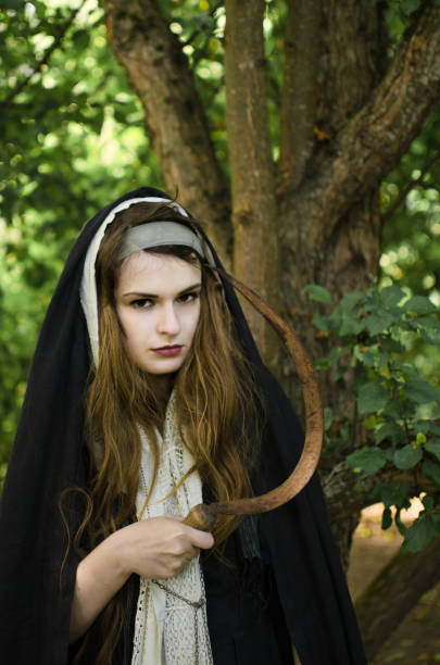 istock wicked witch with a sickle in her hands 1050482610