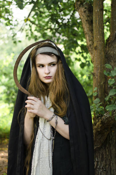 istock wicked witch with a sickle in her hands 1050482648