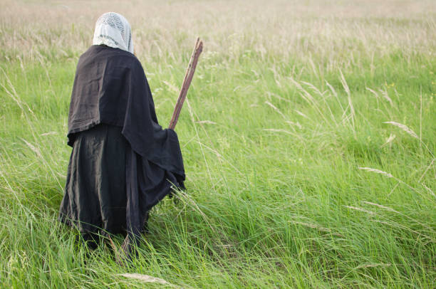 istock witch with a broom on a walk in a wild field 1050485572