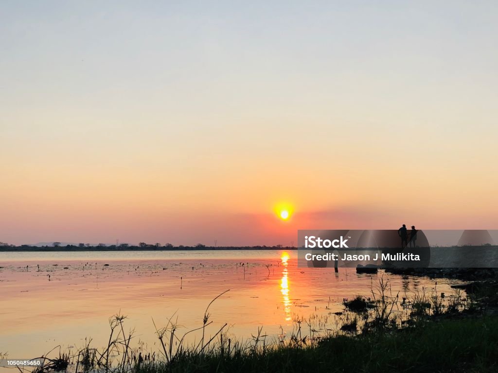 Kafue River Sunset Kafue, Zambia - September 16, 2018: Sunset at the Kafue River, Southern Zambia Beach Stock Photo