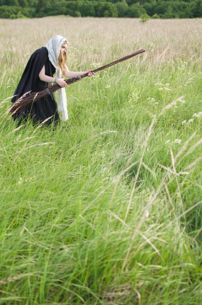 istock witch with a broom on a walk in a wild field 1050490238