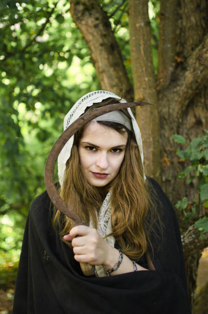 istock wicked witch with a sickle in her hands 1050490444
