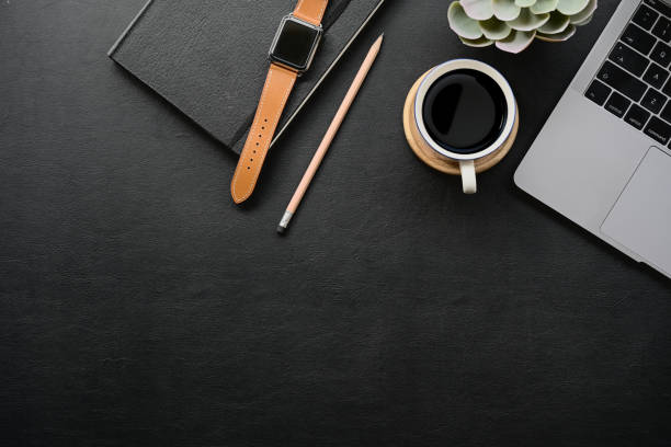istock Dark leather desk with home office gadget and copy space. 1050511110